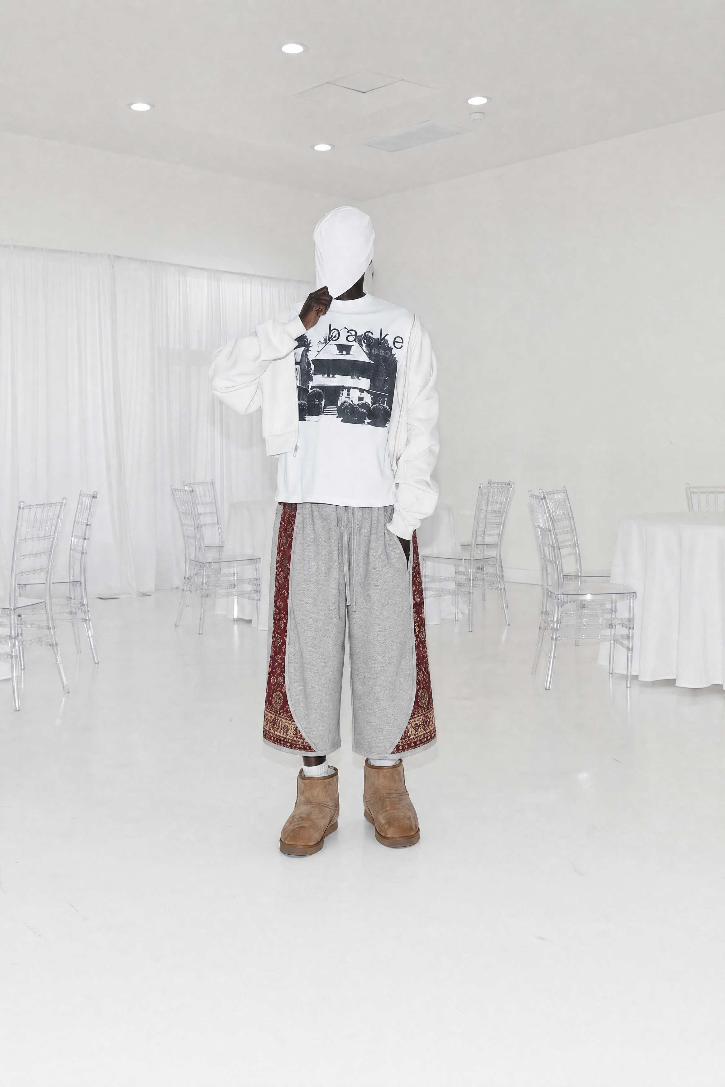 Editorial fashion campaign featuring a model in a bright monochrome space